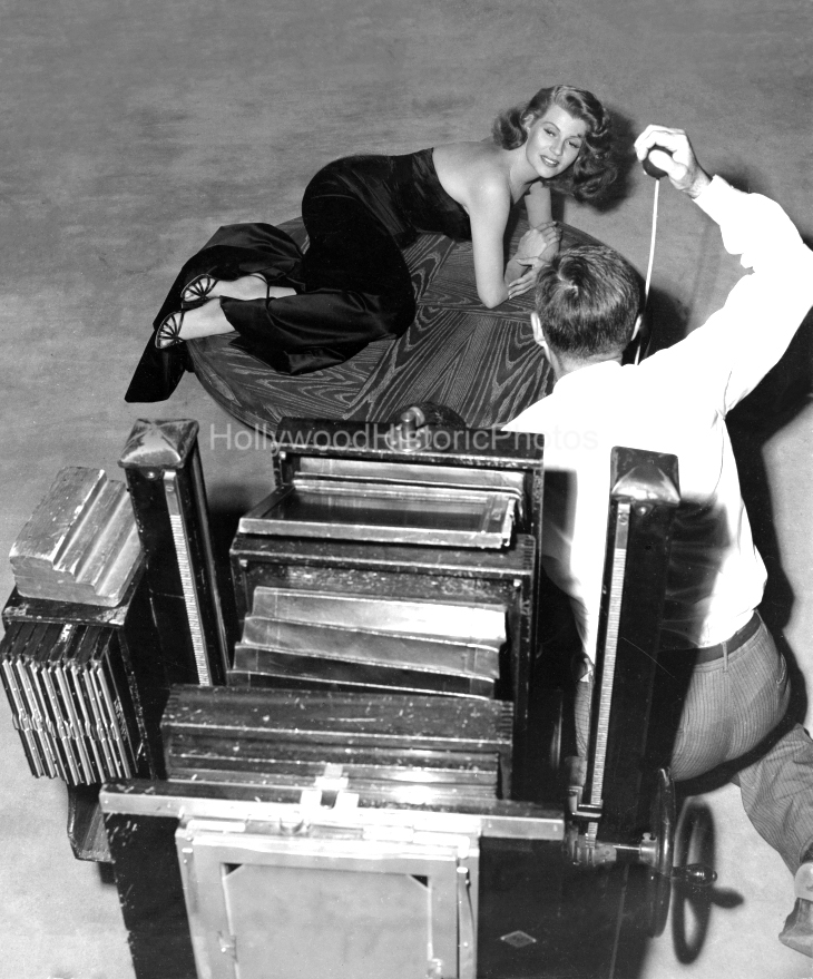 Rita Hayworth 1946 3 With still photographer Bob Coburn on the set of Gilda at Columbia Studios wm.jpg